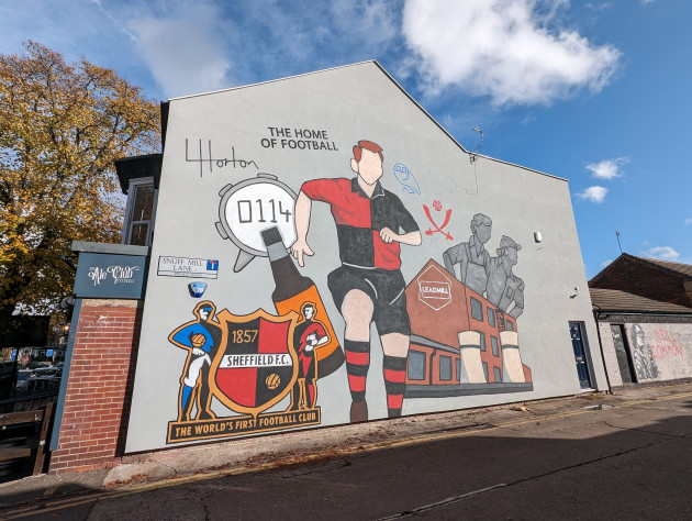 Mural of a faceless footballer in the Sheffield FC kit surrounded by other Sheffield icons